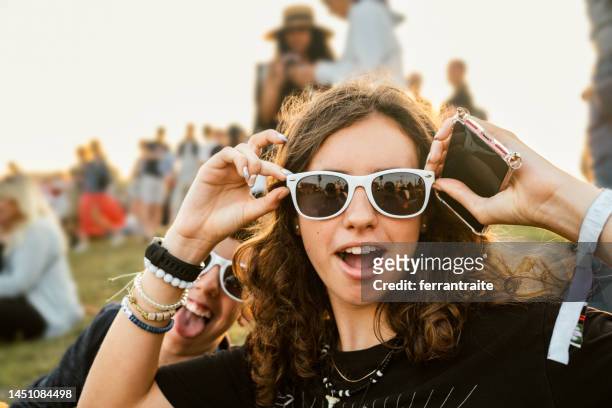 teenagers goofing around at music festival - youth culture stock pictures, royalty-free photos & images