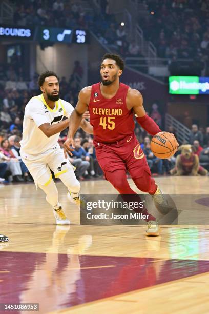 Donovan Mitchell of the Cleveland Cavaliers drives to the basket around Mike Conley of the Utah Jazz during the first quarter at Rocket Mortgage...