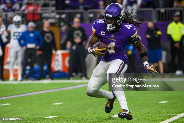 Dalvin Cook of the Minnesota Vikings runs with the ball in the fourth quarter of the game against the Indianapolis Colts at U.S. Bank Stadium on...