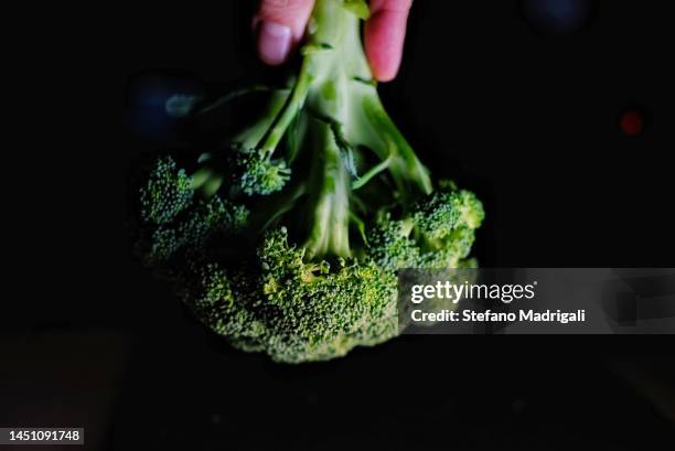 green broccoli on a black background - makrobiotik stock-fotos und bilder