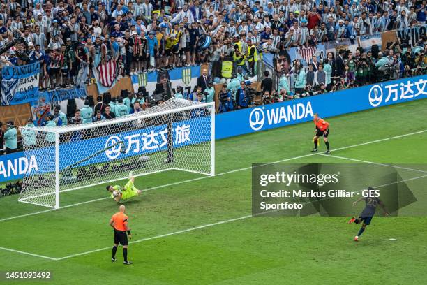 Emiliano Martinez of Argentina saves a penalty during shoot out of Kingsley Coman of France during the FIFA World Cup Qatar 2022 Final match between...