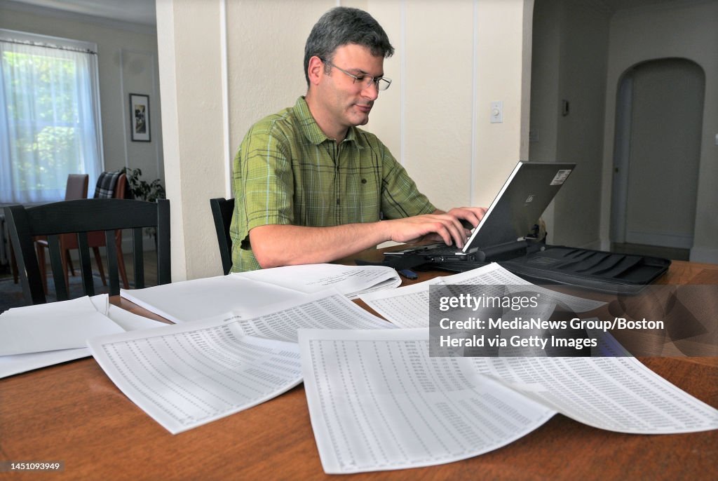 (08/20/10 Brookline, MA) Paul Willen, Boston Federal Reserve economist works with credit reports on the dining room table at his home. Staff Photo by Patrick Whittemore. Saved in Saturday and Ad Fin and archive