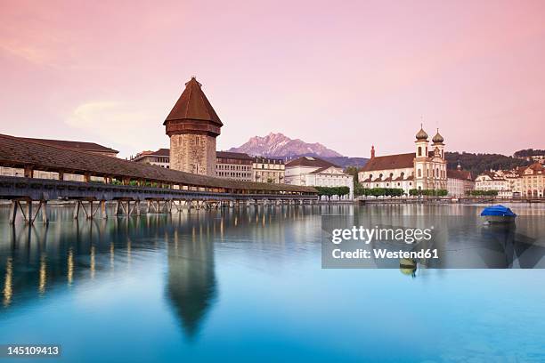 switzerland, lucerne, view of water tower, bridge and church in morning - luzern foto e immagini stock