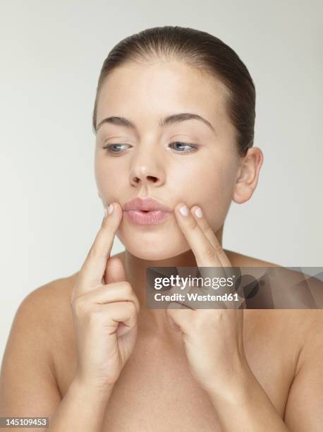 young woman doing face massage, close up - facial massage stock pictures, royalty-free photos & images