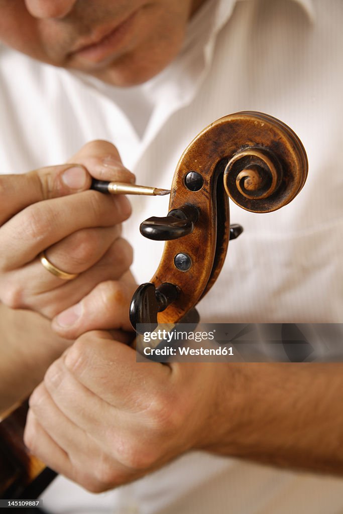 Germany, Upper Bavaria, Schaeftlarn, Violin maker making violin, close up