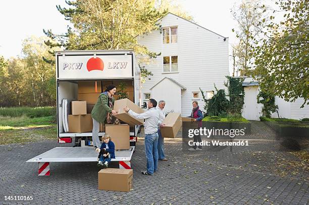 germany, bavaria, grobenzell, family loading boxes into truck for moving house - removal van stock pictures, royalty-free photos & images