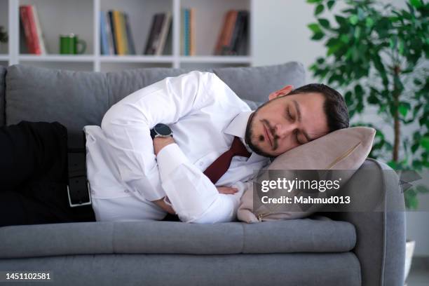 businessman sleeps on the sofa - dozes stock pictures, royalty-free photos & images