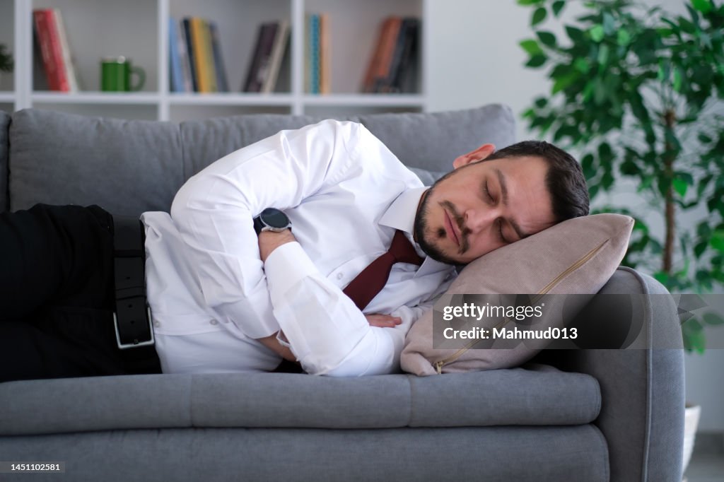 Businessman sleeps on the sofa