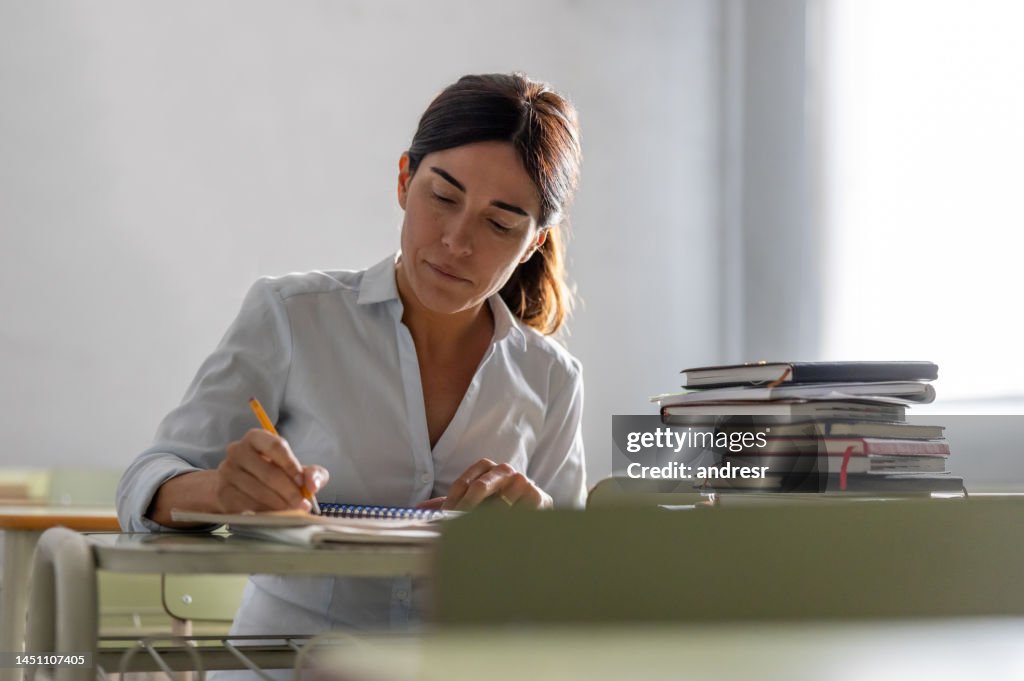Adult woman going back to school and writing in her notebook
