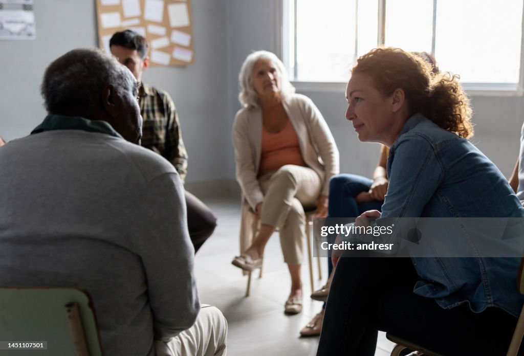 People sharing stories in a group therapy session