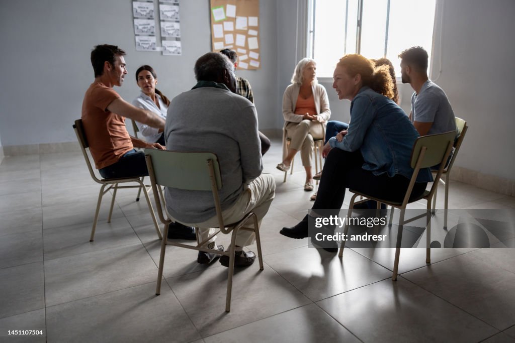 Group of people talking in a therapy session