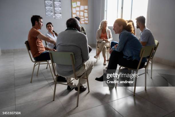 group of people talking in a therapy session - aa meeting stock pictures, royalty-free photos & images