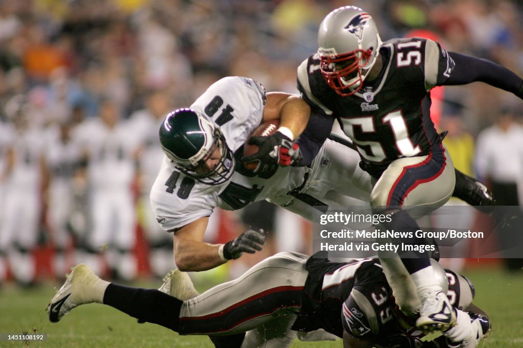 (8/13/04-Foxboro, MA) The Eagles Jon Ritchie goes horizontal after being hit by Patriots Guss Scott (bottom) and Don Davis as the New England Patriots play the Phili Eagels at Gillette Stadium, 8/13/04. (081304patssc22-staff photo by stuart cahill,