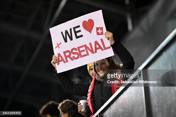 An Arsenal fan holds up a banner during the UEFA Women's Champions League group C match between FC Zürich and Arsenal at WeFox Arena on December 21,...