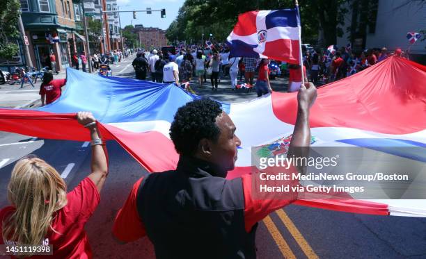 Carlos Melo waves a Dominican flag during the Dominican Parade along Centre Street in Jamaica Plain, Sunday, August 13, 2017. Staff photo by Angela...