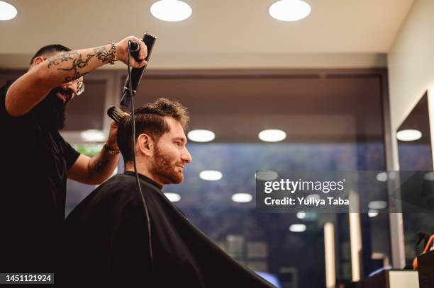 styling men's hair in a beauty salon - hairdresser tools stock pictures, royalty-free photos & images