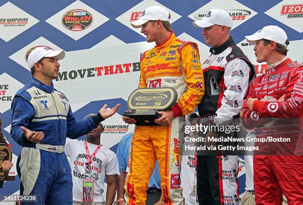 Loudon, NH)Second place finisher Oriol Servia questions winner Ryan Hunter-Reay as 3rd place finisher Scott Dixon looks on in Victory Lane. IZOD...