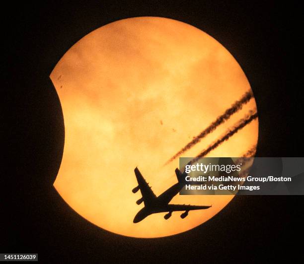 Winthrop,MA. With just a few minutes left before today's rare solar eclipse ends, an Etihad Airlines, Airbus A380, the world's largest passenger jet,...