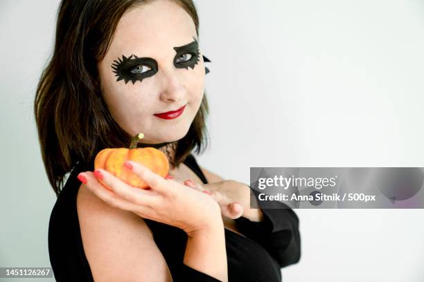 woman with halloween makeup on face holds pumpkin in hand,turkey - ugly black women ストックフォトと画像