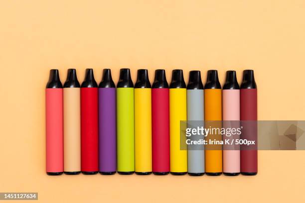 assortment of disposable e-cigarettes on a light background nicotine - electronic cigarette ストックフォトと画像