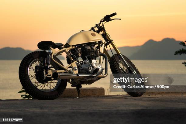 close-up of motorcycle on road against sky during sunset,el nido,palawan,philippines - customised stock pictures, royalty-free photos & images