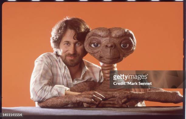 Director Steven Spielberg poses with E.T. At Carlo Rimbaldi studio in April, 1982 in Los Angeles, California.