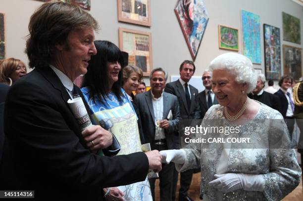 Britain's Queen Elizabeth II meets singer Paul McCartney as she visits the Royal Academy of Arts in central London, on May 23, 2012. AFP PHOTO / POOL...