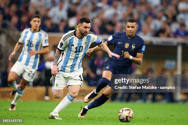 Kylian Mbappe of France vies with Lionel Messi of Argentina during the FIFA World Cup Qatar 2022 Final match between Argentina and France at Lusail...
