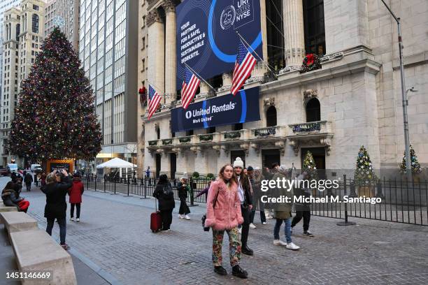 People walk past the New York Stock Exchange during afternoon trading on December 21, 2022 in New York City. Stocks closed strong today for a second...