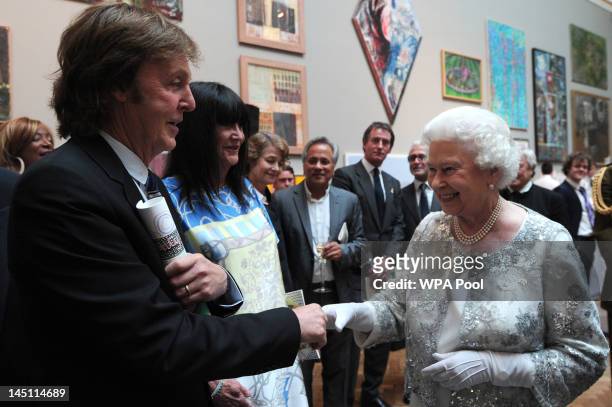 Queen Elizabeth II meets Sir Paul McCartney at a special 'Celebration of the Arts' event at the Royal Academy of Arts on May 23, 2012 in London,...