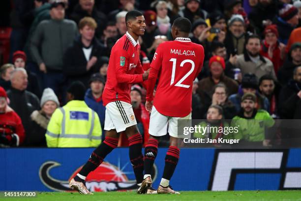 Marcus Rashford of Manchester United celebrates scoring their side's second goal with teammate Tyrell Malacia during the Carabao Cup Fourth Round...