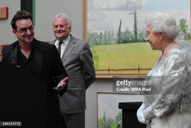 Queen Elizabeth II listens as Bono makes a citation at a special 'Celebration of the Arts' event at the Royal Academy of Arts on May 23, 2012 in...