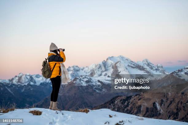 beautiful woman looking through binoculars - woman looking through ice stock pictures, royalty-free photos & images