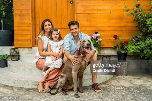 happy family enjoying a summer day at the front yard. - eastern european man in front of house stock pictures, royalty-free photos & images