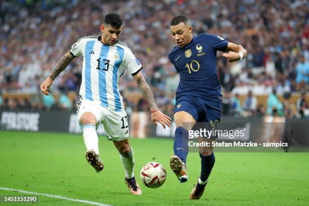 Kylian Mbappe of France vies with Christian Romero of Argentina during the FIFA World Cup Qatar 2022 Final match between Argentina and France at...