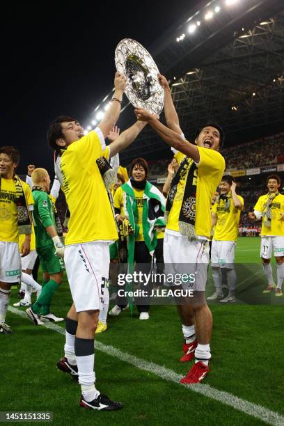 Koki Mizuno and Masato Kudo of Kashiwa Reysol lift the trophy at the award ceremony following the J.League J1 match between Urawa Red Diamonds and...