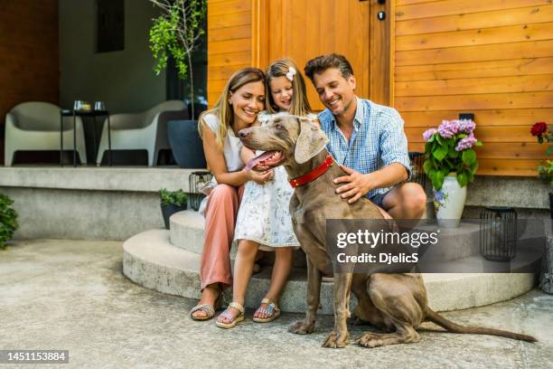 happy family enjoying a summer day at the front yard. - eastern european man in front of house stock pictures, royalty-free photos & images