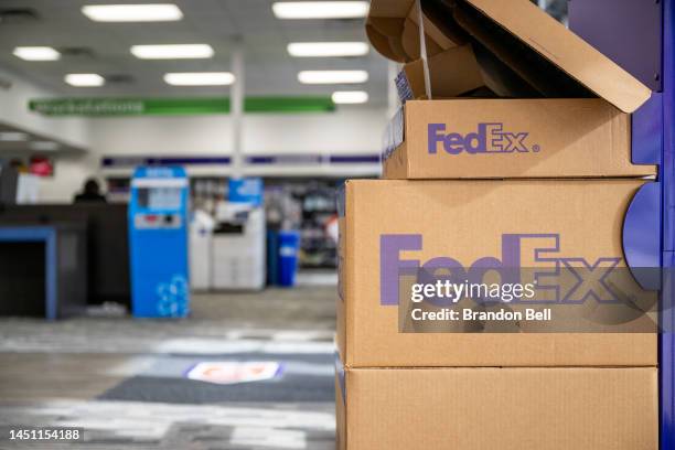 FedEx shipping boxes at a FedEx facility on December 21, 2022 in Houston, Texas. FedEx's sales and profits fell last quarter as company shares...