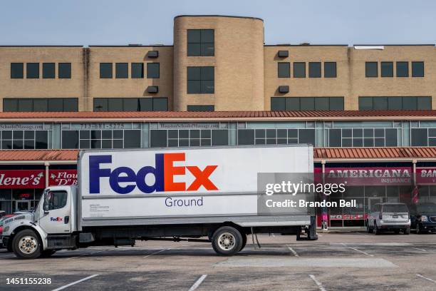 FedEx truck parked in a parking lot near a FedEx facility on December 21, 2022 in Houston, Texas. FedEx's sales and profits fell last quarter as...
