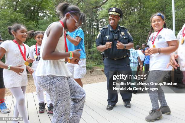 Boston Police Superintendent-in-Chief William Gross joins with campers from Village 3 for the first-ever ?Dance with a Cop? competition at YMCA Camp...