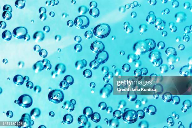 transparent blue water with bubbles. - cream splash stock-fotos und bilder