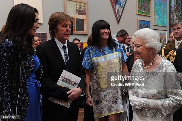Queen Elizabeth II meets Sir Paul McCartney and his wife Nancy Shevell at a special 'Celebration of the Arts' event at the Royal Academy of Arts on...