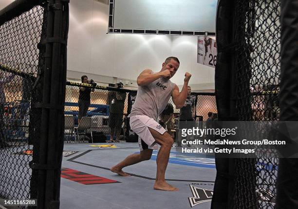 Boston, MA)Marcus Davis shadow boxes in the cage as UFC fighters spar with their trainers and talk to the media during an availability at the John B....
