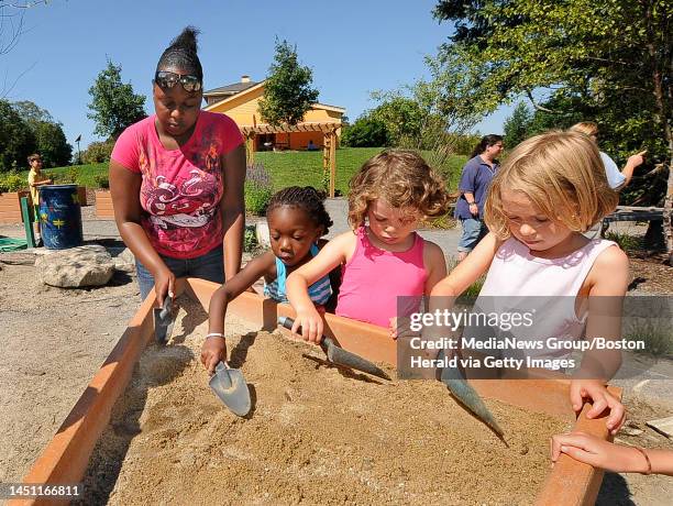 Leader in Training Jolly Joseph works with young campers Awa Dabin, Adina Haess and Lena Cisler with a sandbox project. Kids enjoy the summer camp at...