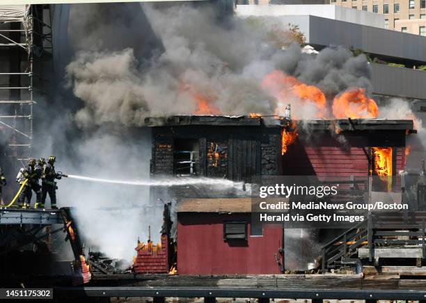 Boston firefighters battled a lunch time fire at the pier where the Boston Tea Party boat is normally docked. Thousands of people watched as the fire...