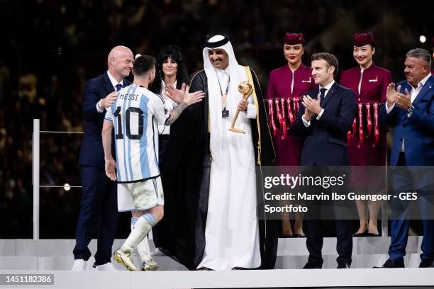 Lionel Messi of Argentina receives his Golden Ball trophy by FIFA President Gianni Infantino, Sheikh Tamim bin Hamad Al Thani, Emir of Qatar, and...