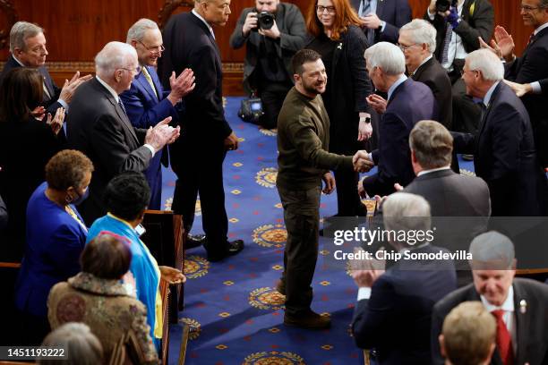 President of Ukraine Volodymyr Zelensky greets lawmakers as he arrives to addresses a joint meeting of Congress in the House Chamber of the U.S....