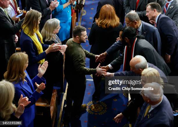 President of Ukraine Volodymyr Zelensky greets lawmakers as he arrives to addresses a joint meeting of Congress in the House Chamber of the U.S....