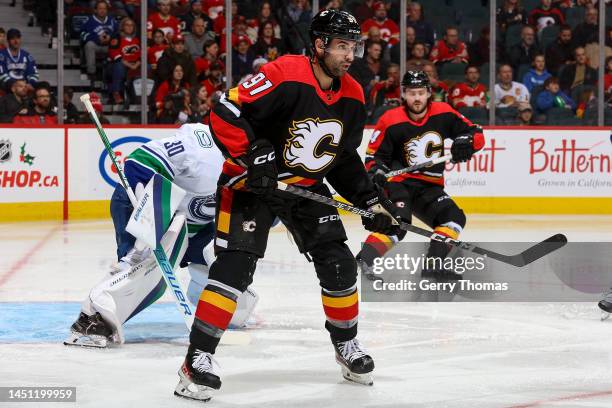 Nazem Kadri of the Calgary Flames battles against the Vancouver Canucks at Scotiabank Saddledome on December 14, 2022 in Calgary, Alberta, Canada.