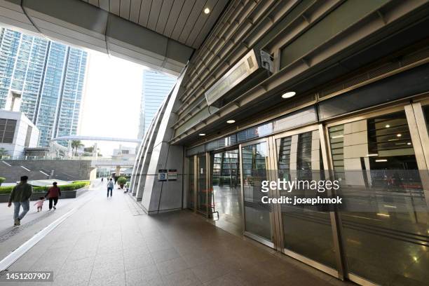 mtr exit d of kowloon station, hong kong - kowloon walled city stock pictures, royalty-free photos & images